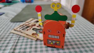 A balsa wood robot, standing on a table. Definitely not a gundam 