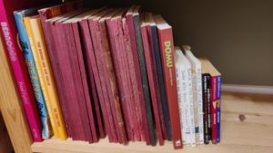 A shelf of books. Broons and Oor Wullie annuals, a copy of Domu, a collection of Nigel Molesworth books. 