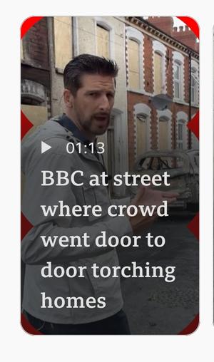 Screenshot of bbc video with description "BBC at street where crowd went door to door torching homes" 
